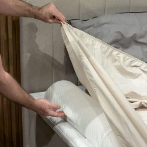 Bed rail fall protection above fitted sheet